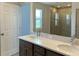 Bathroom with double sinks, shower and a large mirror at 2036 Iorio Dr, St Cloud, FL 34771