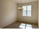 Bright dining room illuminated by a modern chandelier and a large window at 2036 Iorio Dr, St Cloud, FL 34771