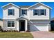 Charming two-story home featuring stone accents, a two-car garage, and a well-maintained lawn at 2036 Iorio Dr, St Cloud, FL 34771