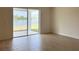 Sunny room with sliding glass doors lead to a patio overlooking a serene lake at 2036 Iorio Dr, St Cloud, FL 34771