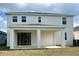 Back exterior of a two-story home with a covered patio at 2036 Iorio Dr, St Cloud, FL 34771