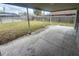 Spacious backyard with a grassy lawn and wood fence, viewed from a covered patio space at 204 W Cottesmore Cir, Longwood, FL 32779