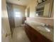 Bathroom with granite counters, wood cabinets, and a tiled shower, offering a sleek design at 204 W Cottesmore Cir, Longwood, FL 32779