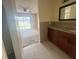 Bathroom with granite countertops, wood cabinets, and a view to the backyard at 204 W Cottesmore Cir, Longwood, FL 32779