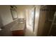 Traditional bathroom featuring granite vanity top, framed mirror, and glass door shower at 204 W Cottesmore Cir, Longwood, FL 32779