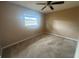 Comfortable carpeted bedroom with a ceiling fan and a bright window at 204 W Cottesmore Cir, Longwood, FL 32779
