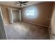 Bright bedroom with carpet flooring, a built-in closet, and a sunny window at 204 W Cottesmore Cir, Longwood, FL 32779
