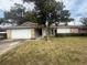 Charming single-story home featuring a well-maintained lawn and mature trees at 204 W Cottesmore Cir, Longwood, FL 32779