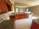 Open kitchen featuring granite countertops, wood cabinets, and tile flooring at 204 W Cottesmore Cir, Longwood, FL 32779