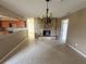 An open-concept floor plan showcases the dining area's chandelier and stone fireplace at 204 W Cottesmore Cir, Longwood, FL 32779