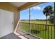 Enjoy this balcony view overlooking a lush green golf course and blue sky on a sunny day at 2808 Osprey Cove Pl # 202, Kissimmee, FL 34746