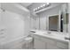 All-white bathroom features a tub, toilet, vanity, mirror, light fixtures, and tile flooring at 2808 Osprey Cove Pl # 202, Kissimmee, FL 34746