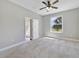 Bedroom with natural light from the window and an adjacent bathroom with a shower and tub at 2808 Osprey Cove Pl # 202, Kissimmee, FL 34746