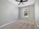 Bedroom with carpet, base molding, natural light from the window, and neutral paint at 2808 Osprey Cove Pl # 202, Kissimmee, FL 34746
