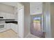 Modern kitchen featuring white cabinets, black countertops, stainless steel appliances, and tiled floors at 2808 Osprey Cove Pl # 202, Kissimmee, FL 34746
