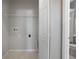 Laundry room with washer/dryer hookups, overhead shelving, and a view to the bathroom at 2808 Osprey Cove Pl # 202, Kissimmee, FL 34746