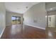 Open-concept living room featuring wood floors, vaulted ceilings, and sliding glass doors leading to a balcony at 2808 Osprey Cove Pl # 202, Kissimmee, FL 34746