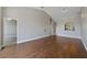 Large living room features hardwood floors, doorways leading to other rooms, and a bar that connects to the kitchen at 2808 Osprey Cove Pl # 202, Kissimmee, FL 34746