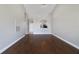 Spacious living room with wood floors, leading into the kitchen via an archway and a hallway with the front door at 2808 Osprey Cove Pl # 202, Kissimmee, FL 34746