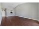 Open concept living room has hardwood floors, view to the kitchen and entrance at 2808 Osprey Cove Pl # 202, Kissimmee, FL 34746