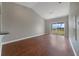 Bright living room featuring wood floors, vaulted ceilings, and sliding glass doors leading to a balcony with a view at 2808 Osprey Cove Pl # 202, Kissimmee, FL 34746