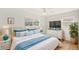 Bright bedroom featuring white furniture, a ceiling fan, and stylish blue accents, creating a serene and inviting atmosphere at 3226 S Peninsula Dr, Daytona Beach Shores, FL 32118