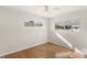 Bedroom with natural light, wood floors, ceiling fan, and two bright windows at 3226 S Peninsula Dr, Daytona Beach Shores, FL 32118