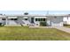 A charming single story home with a well-manicured lawn, white brick exterior, and a one-car garage at 3226 S Peninsula Dr, Daytona Beach Shores, FL 32118
