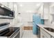 Well-lit kitchen with stainless steel appliances, stone countertops, and tiled backsplash at 3226 S Peninsula Dr, Daytona Beach Shores, FL 32118
