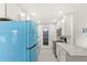 Updated kitchen with stainless appliances, granite countertops, and a retro Smeg refrigerator at 3226 S Peninsula Dr, Daytona Beach Shores, FL 32118