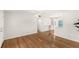 Hardwood floors in the living room enhance the bright, open space; retro fridge in distance at 3226 S Peninsula Dr, Daytona Beach Shores, FL 32118