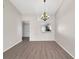 Light-filled dining room features a stylish chandelier, wood flooring, and adjacent pass-through to kitchen at 33 Silver Oak Cir, Kissimmee, FL 34743