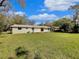 Spacious backyard featuring a well-maintained lawn and a deck at 4112 Grove Pl, Lakeland, FL 33810