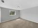 Bedroom featuring a large window for natural light and neutral-toned walls and carpet at 4112 Grove Pl, Lakeland, FL 33810