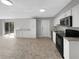 Kitchen featuring white cabinetry, modern appliances, and access to the backyard at 4112 Grove Pl, Lakeland, FL 33810