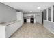 Bright kitchen with white cabinets, black appliances, and spacious tile flooring at 4112 Grove Pl, Lakeland, FL 33810