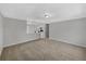 Spacious living room featuring neutral walls and carpet, with kitchen view through glass partition at 4112 Grove Pl, Lakeland, FL 33810