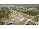 Aerial view of home in a quiet neighborhood with mature trees and established landscaping at 4590 Sw 99Th St, Ocala, FL 34476