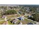 An aerial image shows the home situated on a peaceful corner lot, surrounded by lush greenery and other houses at 4590 Sw 99Th St, Ocala, FL 34476
