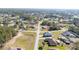 Aerial view displaying the home situated at an intersection of neighborhood roads, surrounded by green spaces and other residences at 4590 Sw 99Th St, Ocala, FL 34476