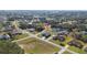 An aerial view captures the single-Gathering home, highlighting its spacious yard and suburban location within the neighborhood at 4590 Sw 99Th St, Ocala, FL 34476