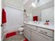Bright bathroom features a shower-tub combo, modern vanity, and wood-look tile flooring at 4590 Sw 99Th St, Ocala, FL 34476