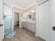 Modern bathroom with double vanity, walk-in shower, and wood-look tile flooring at 4590 Sw 99Th St, Ocala, FL 34476