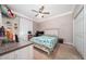 Comfortable bedroom with a ceiling fan, closet, and a dedicated study area with a desk at 4590 Sw 99Th St, Ocala, FL 34476