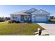 Charming single-story home with a well-manicured lawn and inviting front porch with rocking chairs at 4590 Sw 99Th St, Ocala, FL 34476