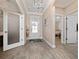 Bright foyer boasting stylish tile flooring, contemporary lighting, and access to multiple rooms at 4590 Sw 99Th St, Ocala, FL 34476