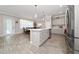 Open kitchen with stainless steel appliances, central island, and adjacent dining area with lots of natural light at 4590 Sw 99Th St, Ocala, FL 34476