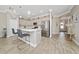 Stylish kitchen with stainless steel appliances, island with bar stool seating, and wood-look tile flooring at 4590 Sw 99Th St, Ocala, FL 34476