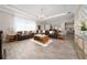 Spacious living area with open layout, elegant furnishings, and wood-look tile flooring at 4590 Sw 99Th St, Ocala, FL 34476