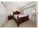 Elegant bedroom with a large wooden bed frame, crown molding, and ample closet space at 4590 Sw 99Th St, Ocala, FL 34476